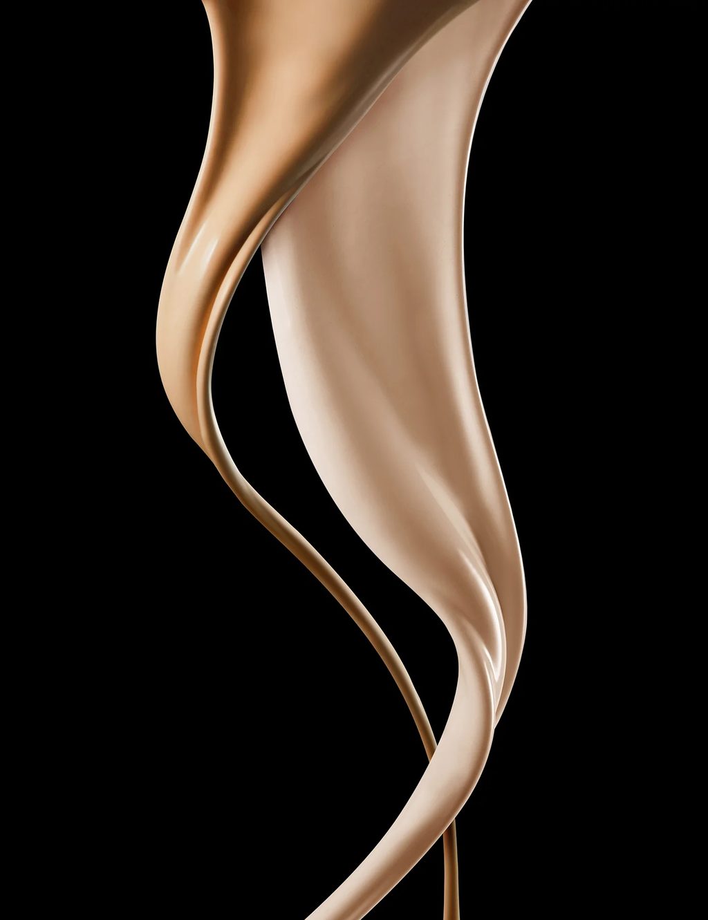 Flowing ribbons of liquid foundation photographed against black